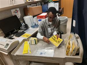 Intern Javion McPherson assembles packets at Bronson 